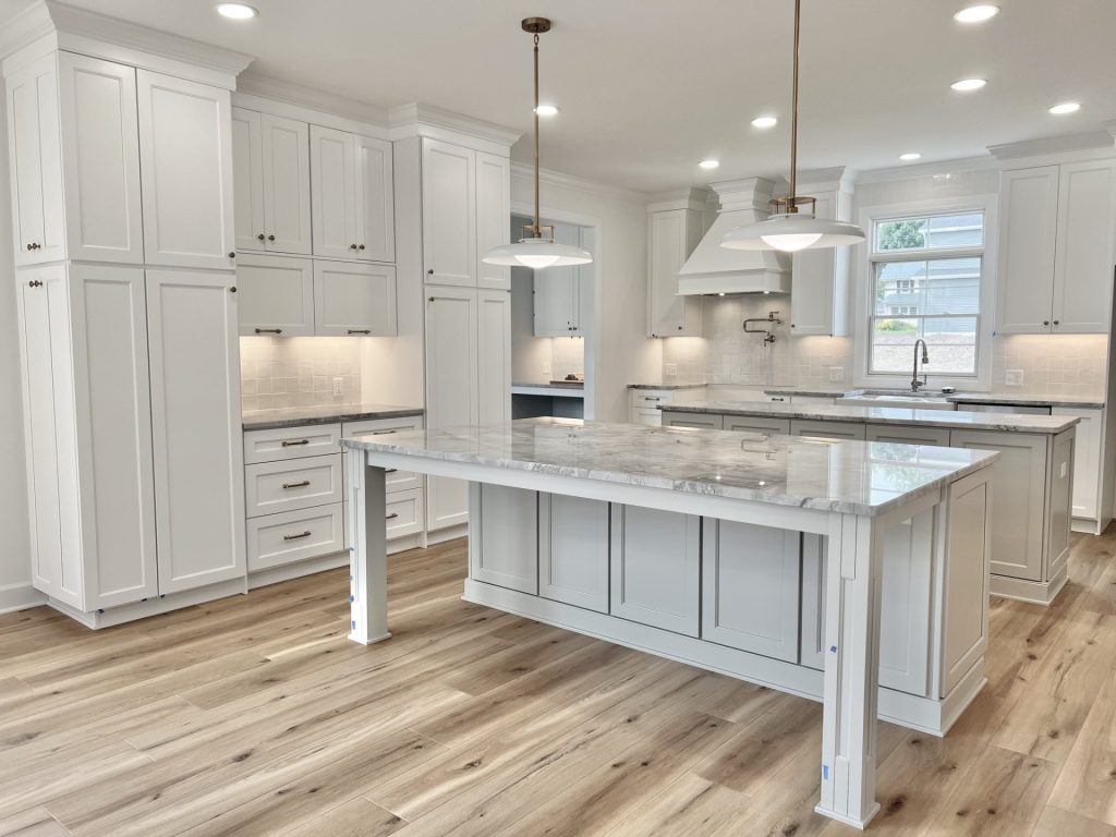 The Willow Oversized Kitchen Island, Workstation, and White Cabinetry with Marble Countertops