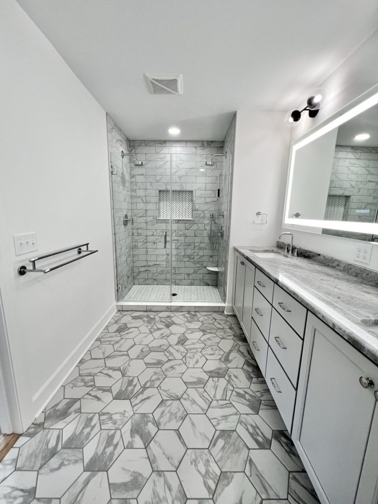 The Willow Master Bathroom in Gray and White with Walk-in Shower, Double Vanity with Gray Mosaic Patterned Tile Floor