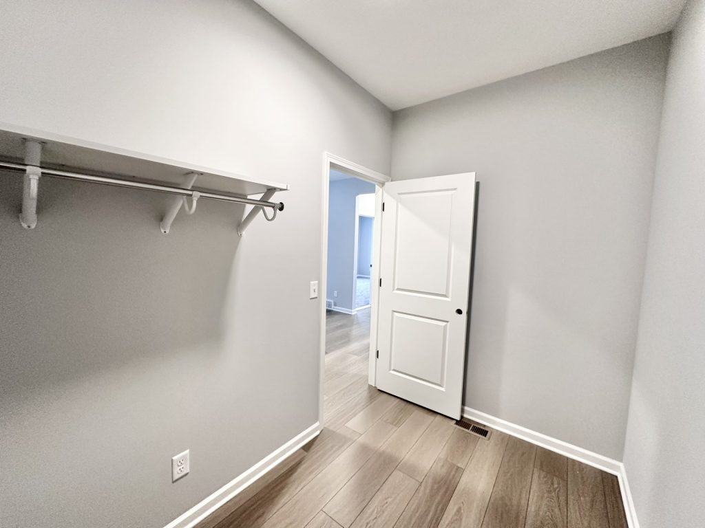 The Kendall Laundry Room with Hanging Shelf, Open Door, Wood-Look Flooring & Gray Walls