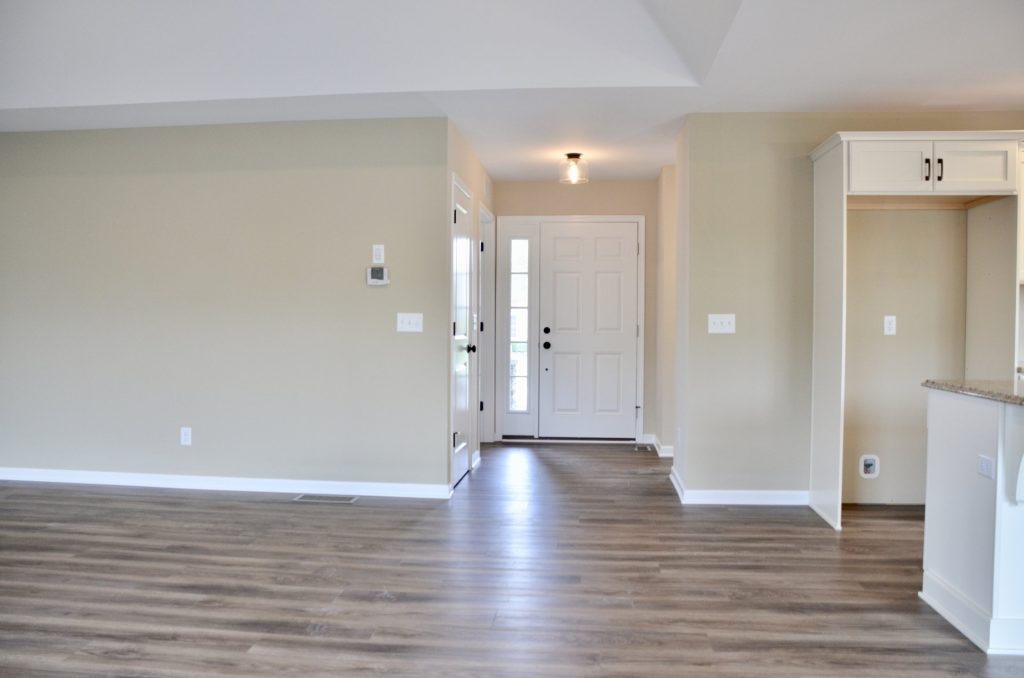 Baybrook-I-Great-Room-with-Front-Entry-View-Wood-Look-Flooring-and-Appliance-Alcove