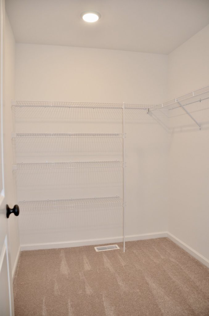 Baybrook-I-Walk-In-Closet-with-Wire-Shelving-Neutral-Carpet-and-White-Walls