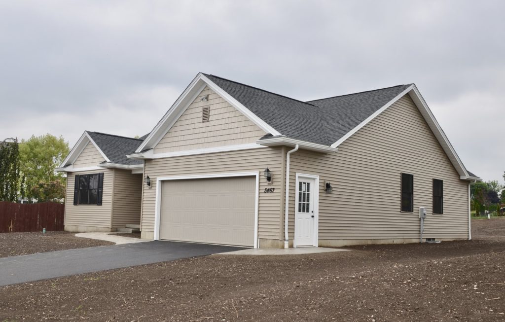 Baybrook-I-1-Story-Craftsman-Style-Home-with-Light-Taupe-Siding-Side-Garage-Door-and-Dark-Shutters