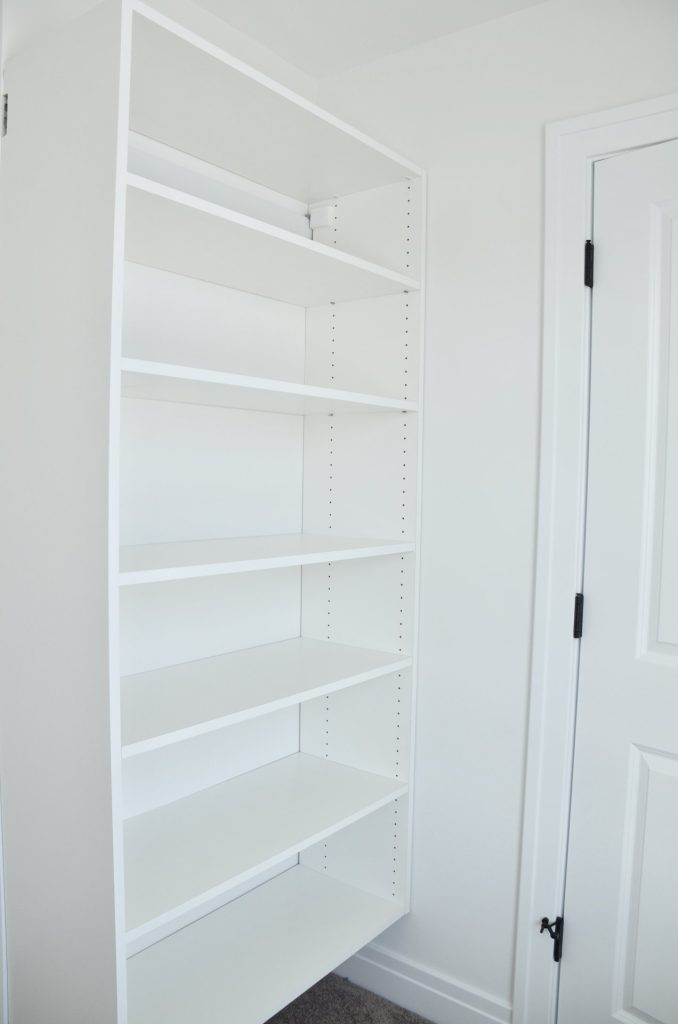The Stratford II Built-In Shelving Detail in Bedroom Closet Area with White Storage Shelves & Neutral Walls