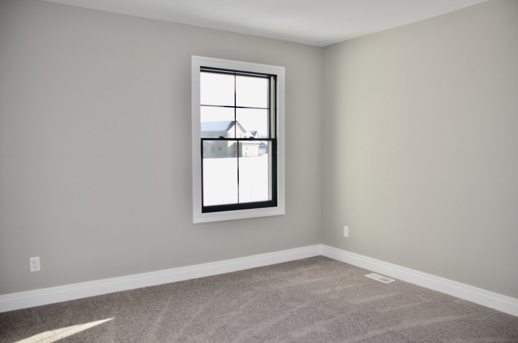 The Stratford II Bedroom with Single Window, Neutral Carpet, Light Walls & Spacious Layout
