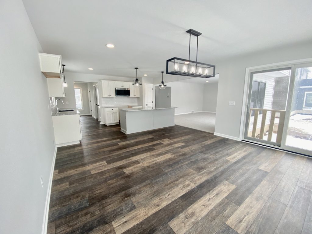 The Cooper I Dinette with Sliding Glass Door, Kitchen Island, Wood-Look Flooring & Great Room View