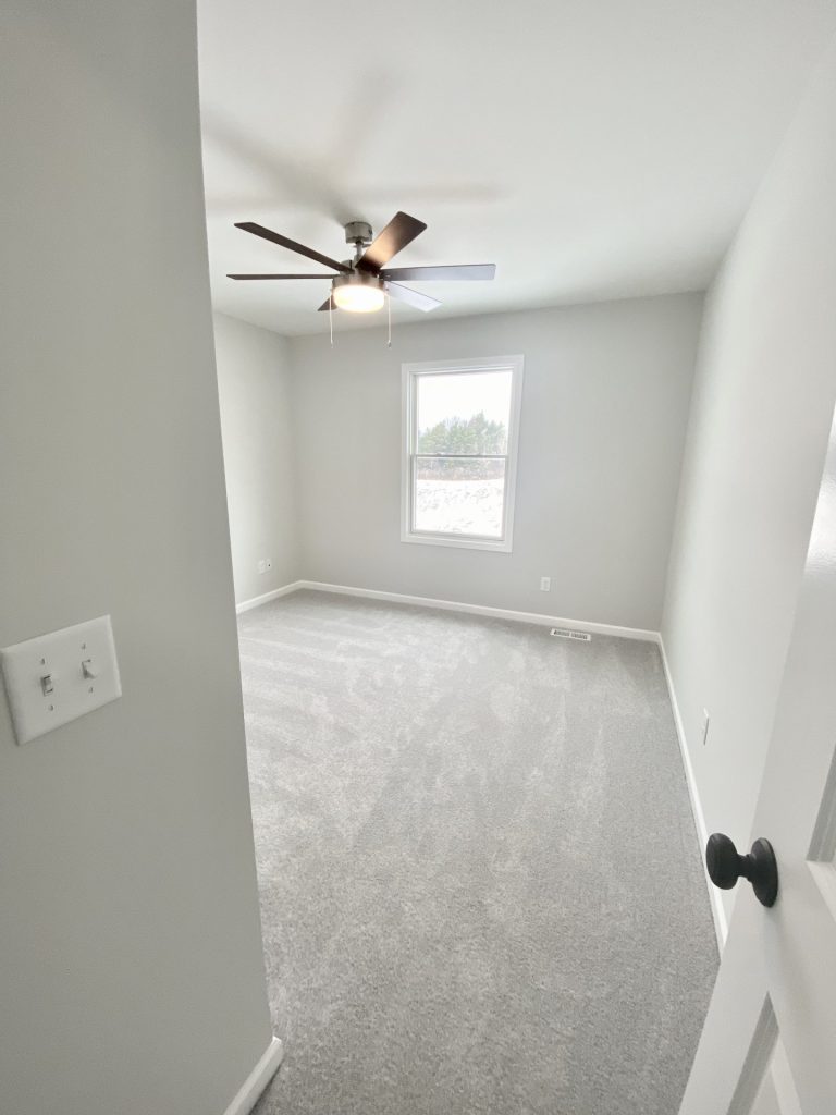 The Cooper I Secondary Bedroom with Light Carpet, Light Walls, Ceiling Fan & Alternate Angle View