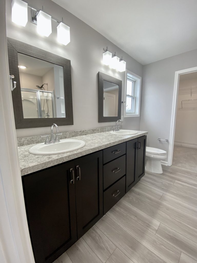The Cooper I Primary Bathroom Double Vanity with Dark Cabinetry, Framed Mirrors, Dual Sinks & Tile Flooring