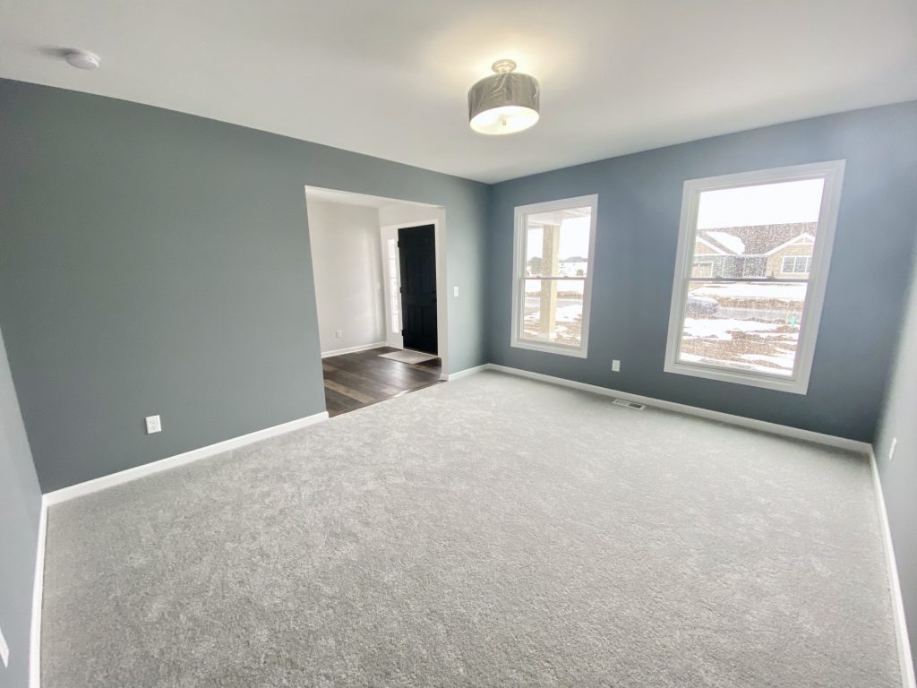 The Cooper I Front Den with Gray Walls, Light Carpet, White Trim & Alternate Angle View
