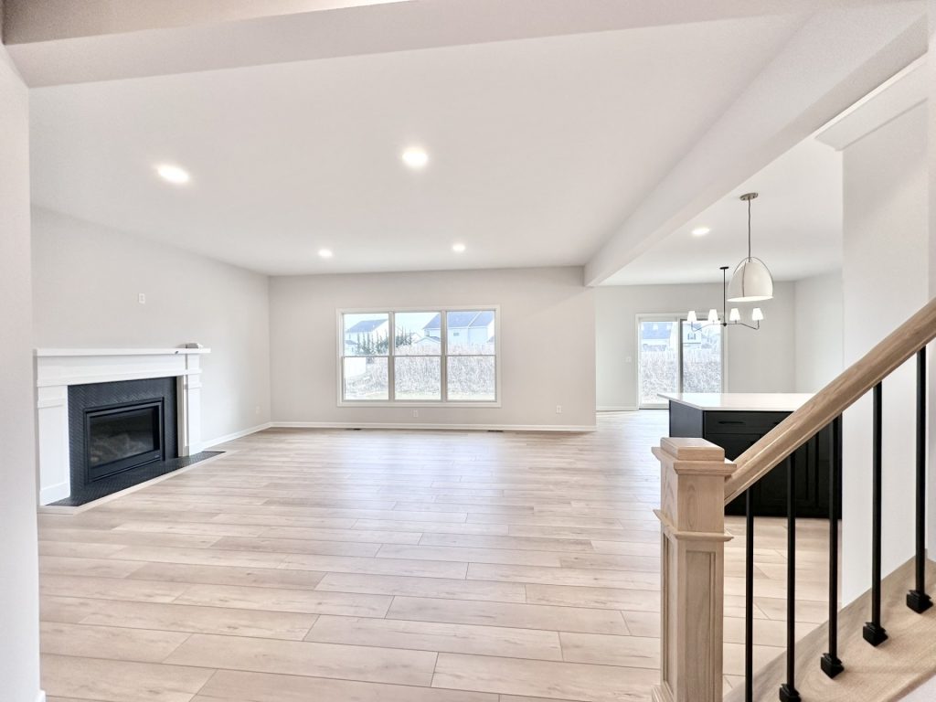 Cooper-Open-Great-Room-Fireplace-Large-Windows-Kitchen-View