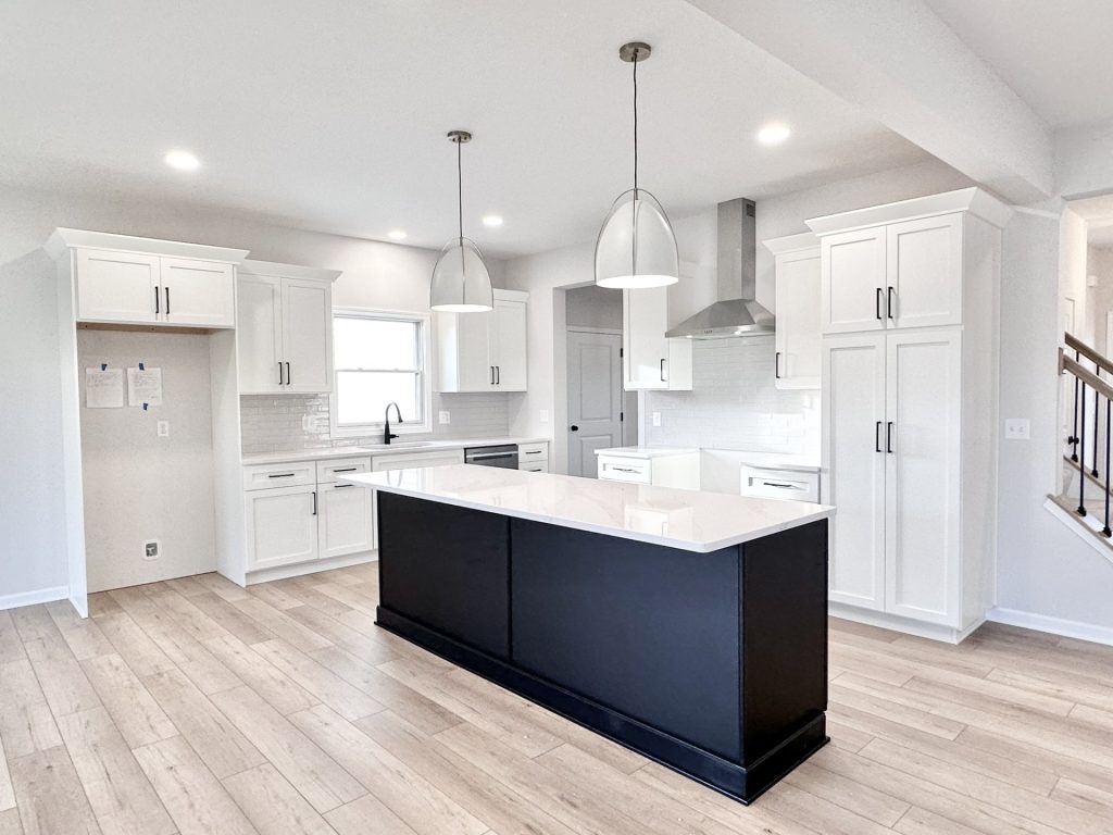 Cooper-Kitchen-White-Cabinetry-Black-Island-Quartz-Counters-Pendant-Lights