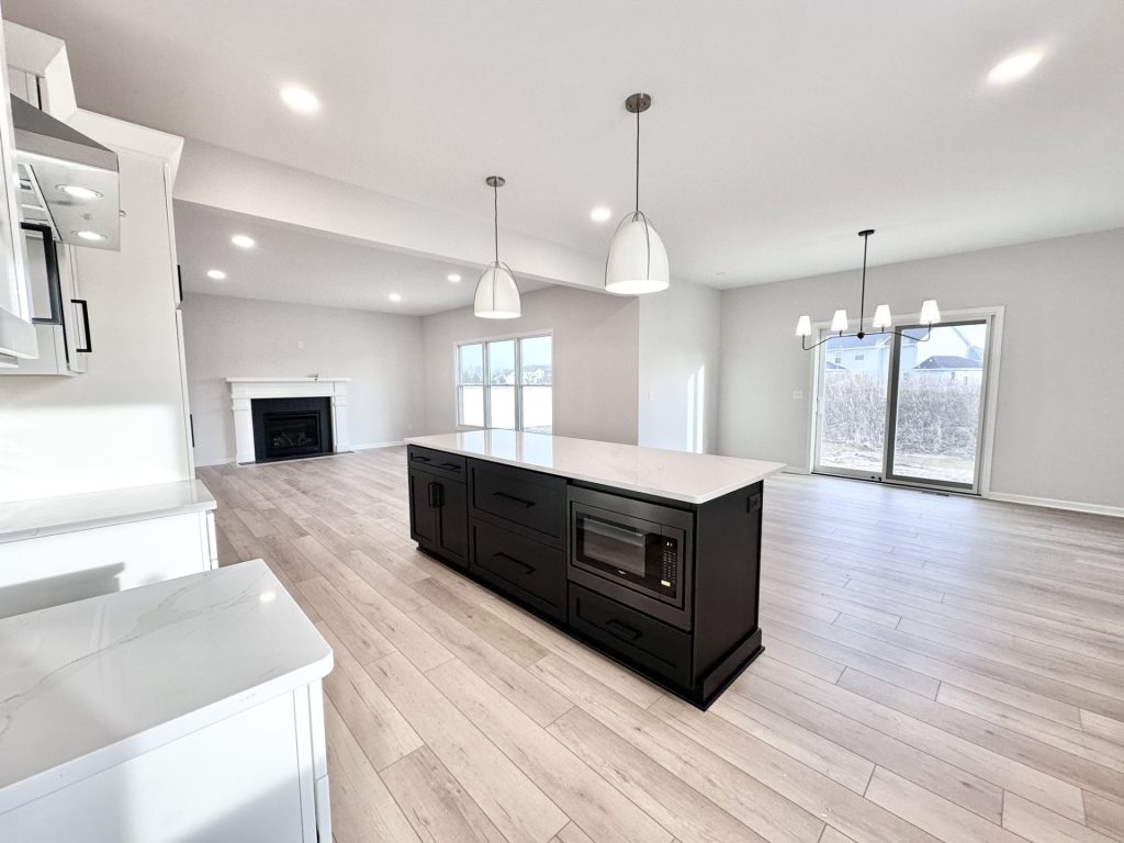 Cooper-Kitchen-Dinette-Black-Island-Built-In-Microwave-Sliding-Door-Fireplace-View