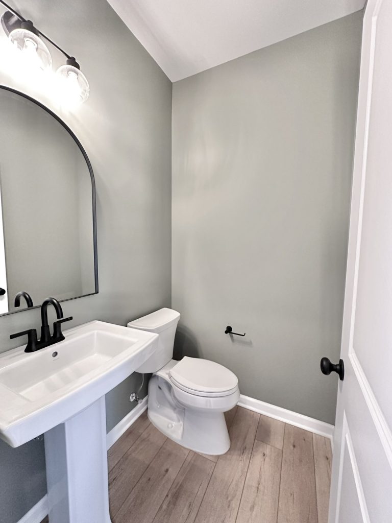 Cooper-Powder-Room-Pedestal-Sink-Arched-Mirror-Gray-Walls