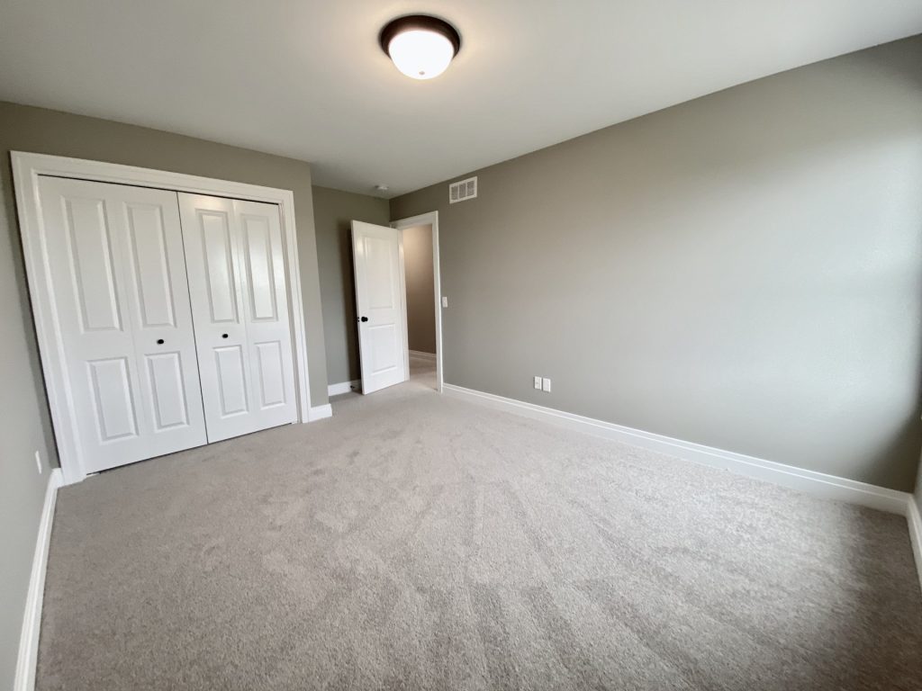 Weston-Secondary-Bedroom-with-Neutral-Carpet-Gray-Walls-and-White-Trim